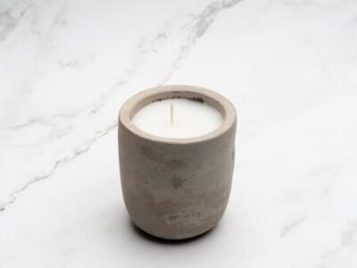 Simple ceramic candle holder on marble surface for a minimalist aesthetic.