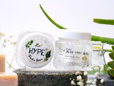 Home Aloe vera skincare products on a natural stone setting with greenery.