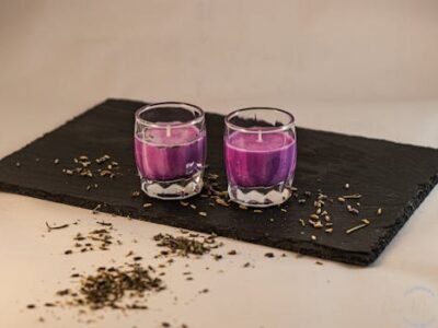 Two purple candles on slate with dried lavender, perfect for relaxation.