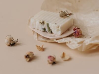 Home Close-up of artisanal soap with dried flowers on wax paper, eco-friendly product
