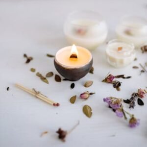 Warm candlelit scene with dried flowers and matches, perfect for relaxation or home decor aesthetics.